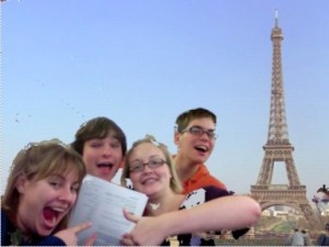 4 grinning students, 1 assignment, and the Eiffel Tower