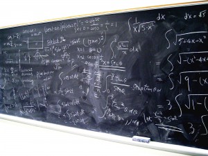 Blackboard with algebra problems written on it.