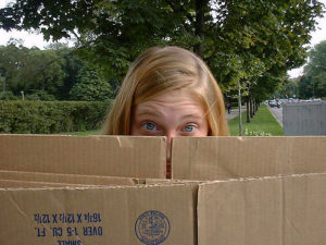 girl looking over a box