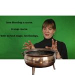 Jane Holbrook gestures over a copper pot.